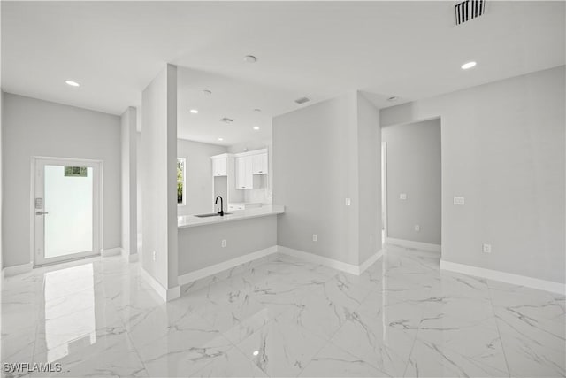 836 Clow St E, Lehigh Acres, FL 33974 - unfurnished living room featuring visible vents, marble finish floor, baseboards, recessed lighting, and a sink