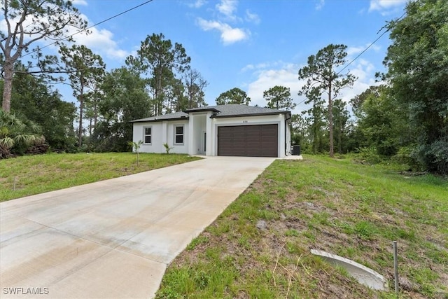 836 Clow St E, Lehigh Acres, FL 33974 - view of front facade with concrete driveway, stucco siding, an attached garage, and a front lawn
