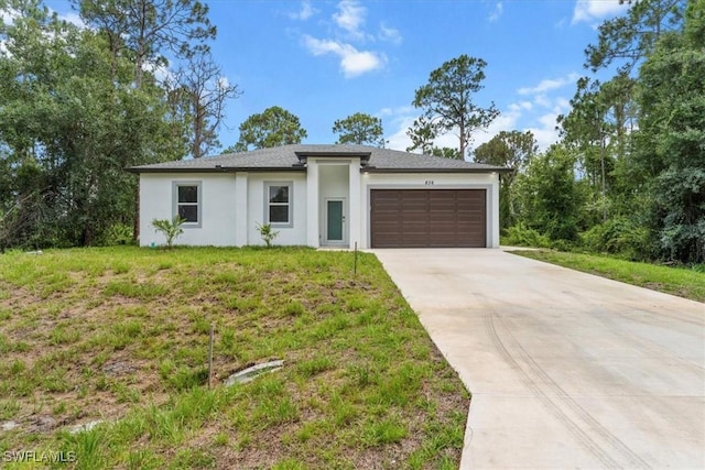 836 Clow St E, Lehigh Acres, FL 33974 - prairie-style home featuring a garage, stucco siding, concrete driveway, and a front yard