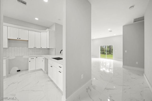 836 Clow St E, Lehigh Acres, FL 33974 - kitchen with light marble finish floors, recessed lighting, backsplash, white cabinetry, and open floor plan