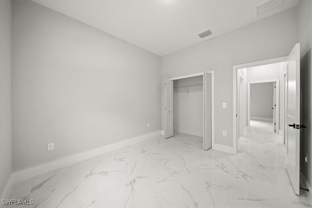 836 Clow St E, Lehigh Acres, FL 33974 - unfurnished bedroom with light marble finish flooring and a closet