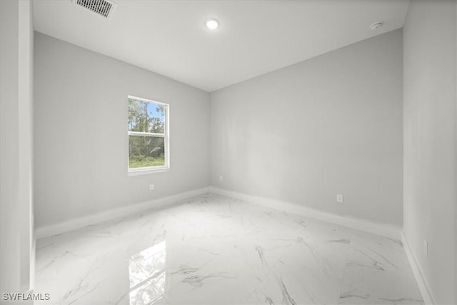 836 Clow St E, Lehigh Acres, FL 33974 - empty room featuring marble finish flooring, a smoke detector, and recessed lighting