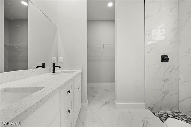 836 Clow St E, Lehigh Acres, FL 33974 - bathroom with marble look tile flooring, double vanity, recessed lighting, a spacious closet, and a marble finish shower