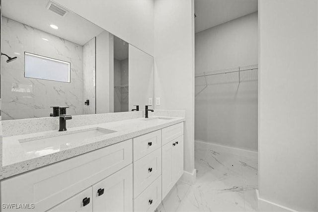836 Clow St E, Lehigh Acres, FL 33974 - full bath with marble finish floors, double vanity, a spacious closet, and a marble finish shower