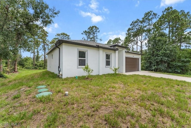 836 Clow St E, Lehigh Acres, FL 33974 - view of front of property featuring an attached garage, stucco siding, concrete driveway, and a front lawn
