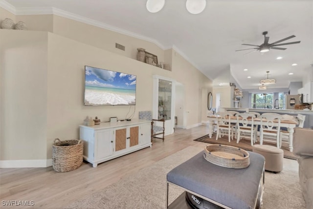 10225 Bismark Palm Way Unit 1626, Fort Myers, FL 33966 - living room featuring crown molding, light wood-style floors, a ceiling fan, baseboards, and vaulted ceiling