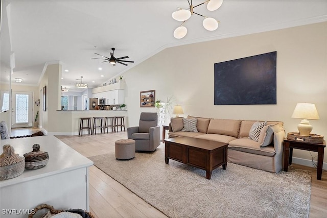 10225 Bismark Palm Way Unit 1626, Fort Myers, FL 33966 - living room featuring crown molding, light wood-type flooring, a ceiling fan, lofted ceiling, and a chandelier