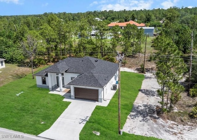 203 E 10th St, Lehigh Acres, FL 33972 - aerial view of property and surrounding area featuring a heavily wooded area