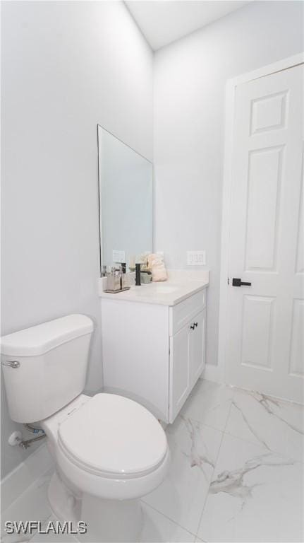203 E 10th St, Lehigh Acres, FL 33972 - half bath featuring marble look tiles, vanity, and toilet