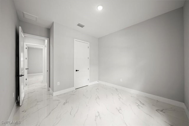 203 E 10th St, Lehigh Acres, FL 33972 - unfurnished bedroom featuring light marble finish floors, baseboards, recessed lighting, and attic access