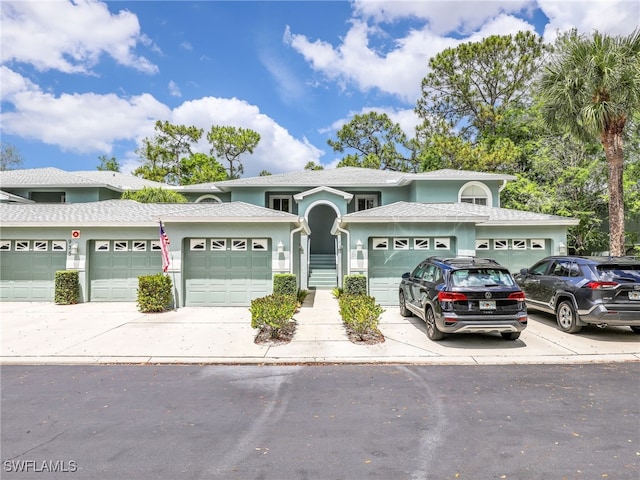 935 New Waterford Dr Unit F204, Naples, FL 34104 - view of front of home featuring a shingled roof, stucco siding, and driveway