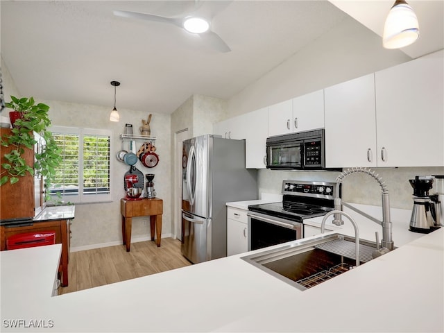935 New Waterford Dr Unit F204, Naples, FL 34104 - kitchen featuring light wood-style flooring, pendant lighting, ceiling fan, light countertops, and appliances with stainless steel finishes