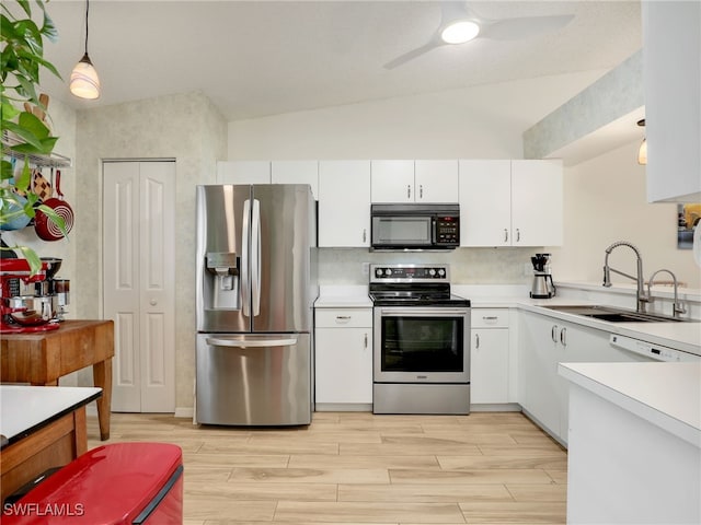 935 New Waterford Dr Unit F204, Naples, FL 34104 - kitchen with a sink, vaulted ceiling, light countertops, white cabinets, and appliances with stainless steel finishes