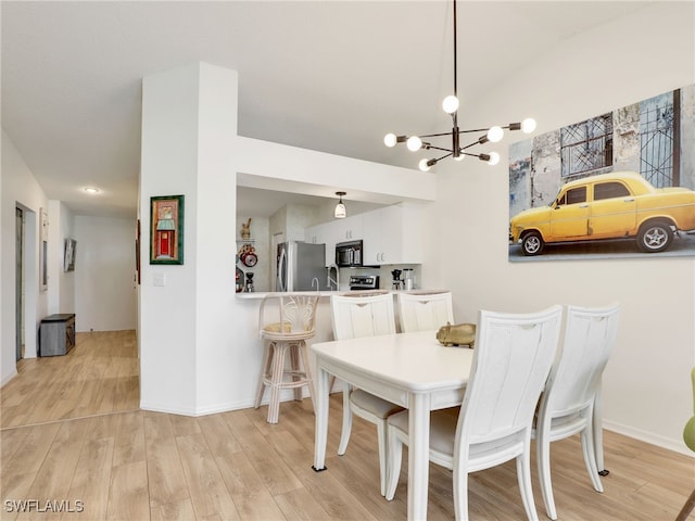 935 New Waterford Dr Unit F204, Naples, FL 34104 - dining room with a chandelier, lofted ceiling, baseboards, and light wood finished floors