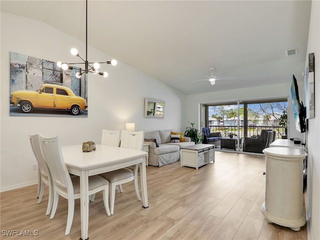 935 New Waterford Dr Unit F204, Naples, FL 34104 - dining area with ceiling fan with notable chandelier, light wood-style flooring, visible vents, and vaulted ceiling
