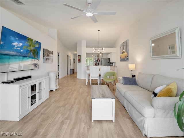 935 New Waterford Dr Unit F204, Naples, FL 34104 - living area with light wood finished floors, lofted ceiling, ceiling fan with notable chandelier, and visible vents