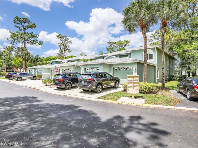 935 New Waterford Dr Unit F204, Naples, FL 34104 - multi unit property with an attached garage, stucco siding, and driveway