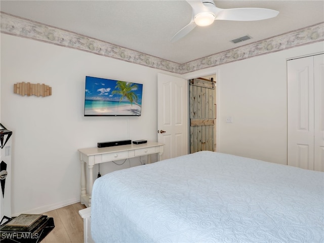 935 New Waterford Dr Unit F204, Naples, FL 34104 - bedroom featuring a ceiling fan, baseboards, visible vents, and light wood-type flooring