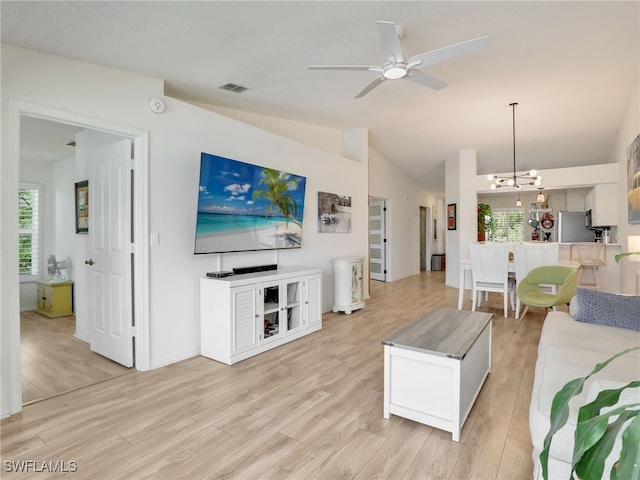 935 New Waterford Dr Unit F204, Naples, FL 34104 - living room with vaulted ceiling, a wealth of natural light, ceiling fan with notable chandelier, and light wood-type flooring