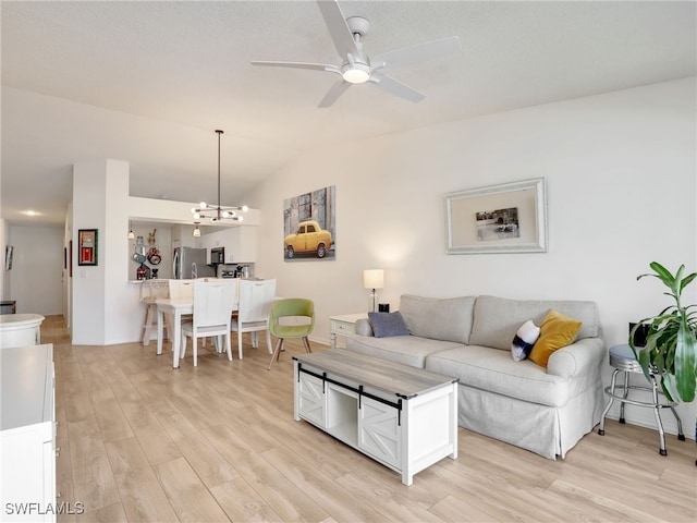 935 New Waterford Dr Unit F204, Naples, FL 34104 - living area featuring vaulted ceiling, ceiling fan with notable chandelier, light wood-type flooring, and baseboards