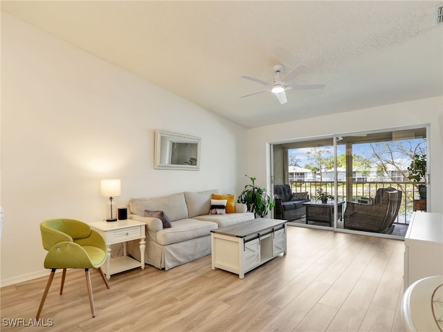 935 New Waterford Dr Unit F204, Naples, FL 34104 - living room featuring vaulted ceiling, light wood-type flooring, a ceiling fan, and visible vents