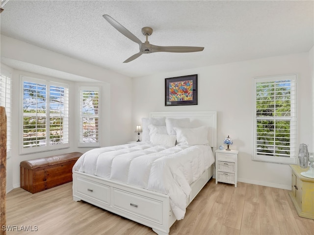 935 New Waterford Dr Unit F204, Naples, FL 34104 - bedroom with ceiling fan, a textured ceiling, baseboards, and light wood-type flooring
