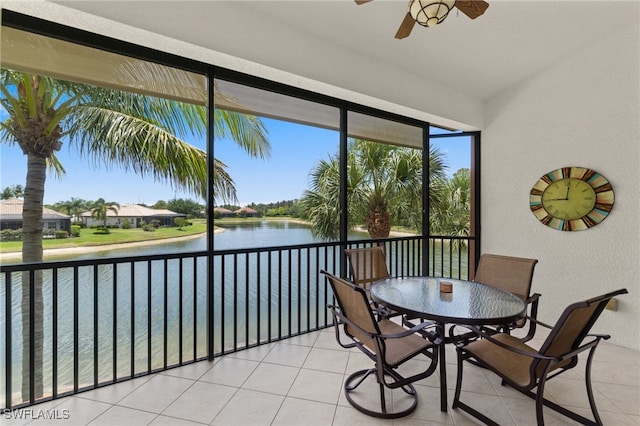 sunroom featuring a water view