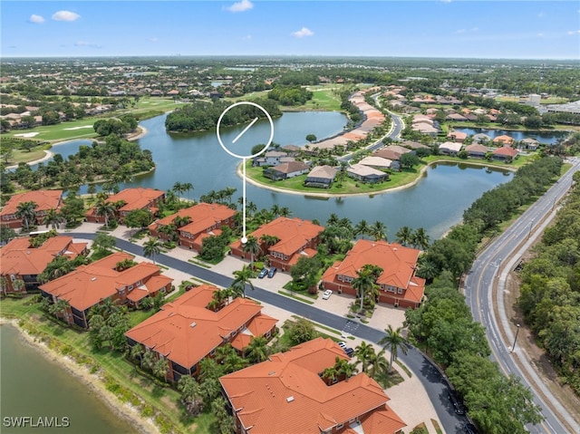 drone / aerial view featuring a water view and a residential view
