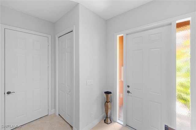 foyer featuring baseboards