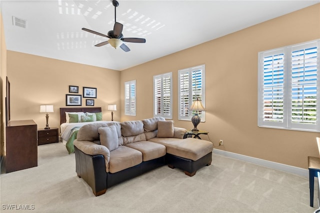 bedroom featuring baseboards, a ceiling fan, visible vents, and light colored carpet