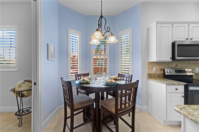 dining area with light tile patterned floors and baseboards