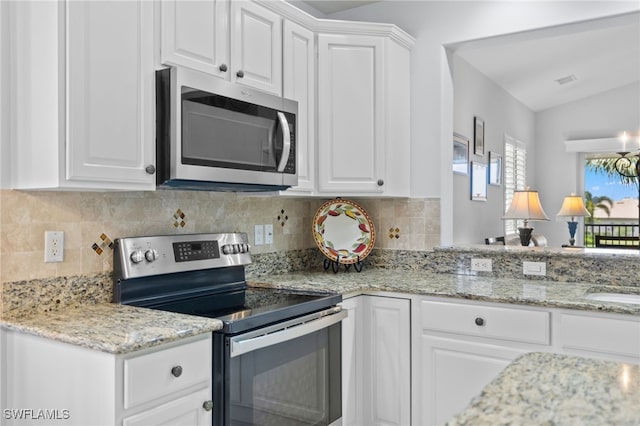 kitchen featuring backsplash, white cabinets, and appliances with stainless steel finishes