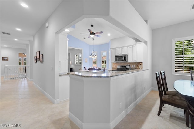 kitchen featuring stainless steel appliances, white cabinetry, a ceiling fan, light tile patterned floors, and light stone countertops