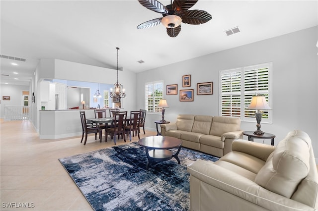 living room featuring lofted ceiling, ceiling fan with notable chandelier, light tile patterned floors, and visible vents