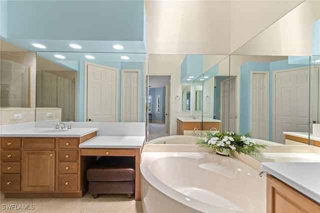 bathroom with a closet, a sink, a shower stall, tile patterned flooring, and a garden tub
