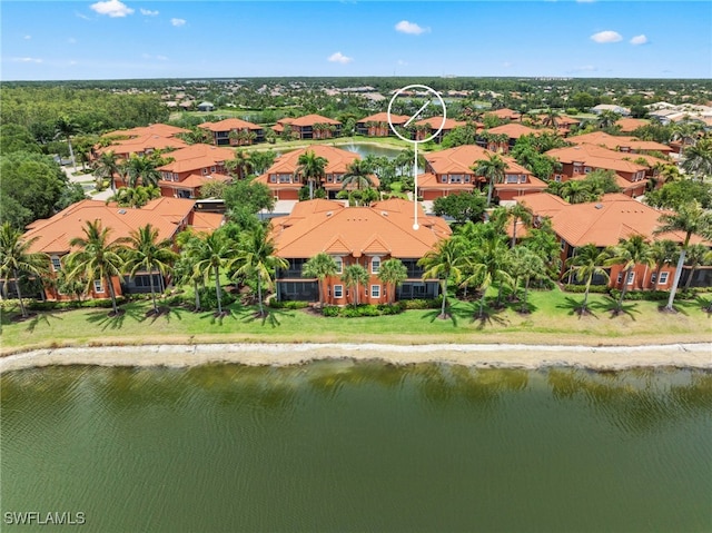 drone / aerial view featuring a water view and a residential view