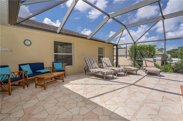 view of patio / terrace with an outdoor living space and glass enclosure