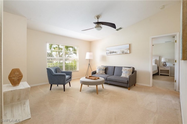 carpeted living area featuring vaulted ceiling, baseboards, a ceiling fan, and visible vents