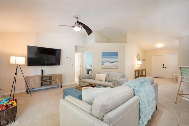 living area featuring baseboards, ceiling fan, and vaulted ceiling