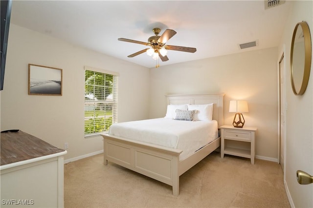 bedroom featuring baseboards, ceiling fan, light colored carpet, and visible vents