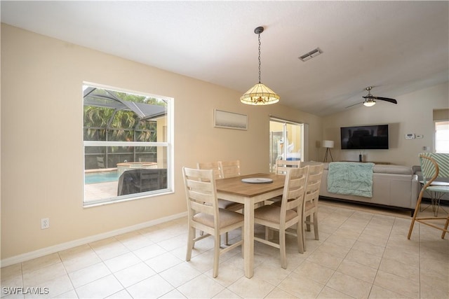dining space with light tile patterned floors, visible vents, a healthy amount of sunlight, and lofted ceiling