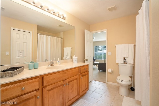 bathroom featuring tile patterned flooring, vanity, toilet, baseboards, and visible vents