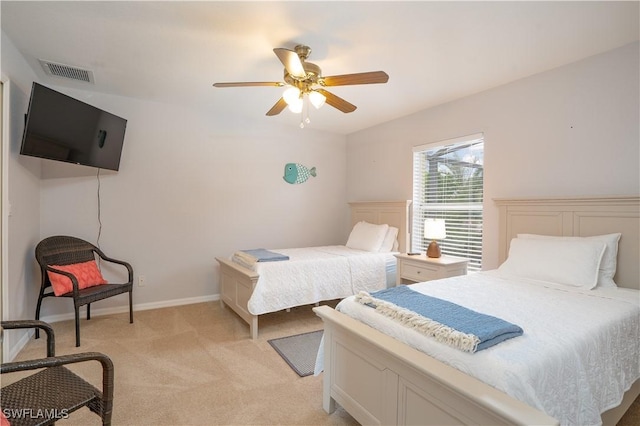 bedroom with visible vents, a ceiling fan, baseboards, and light carpet