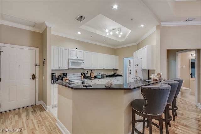 2743 1st St Unit 305, Fort Myers, FL 33916 - kitchen with visible vents, dark countertops, crown molding, and white appliances