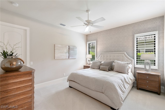 bedroom with baseboards, ceiling fan, visible vents, and carpet floors