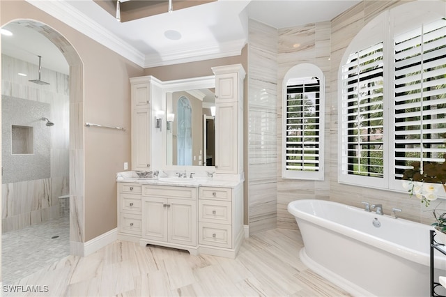 bathroom featuring ornamental molding, vanity, a freestanding bath, and a walk in shower