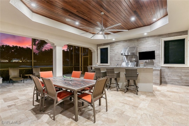 exterior space featuring ceiling fan, area for grilling, and outdoor wet bar