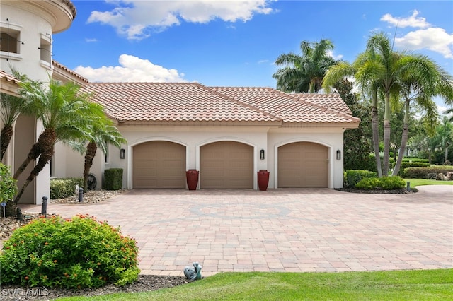garage with decorative driveway