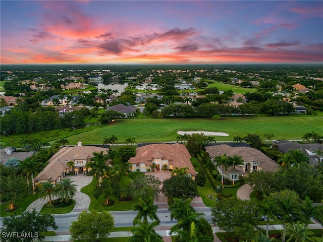drone / aerial view with view of golf course and a residential view