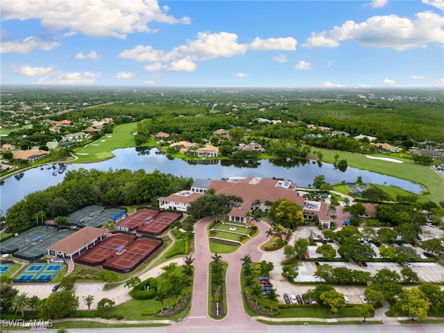drone / aerial view with a water view, golf course view, and a residential view
